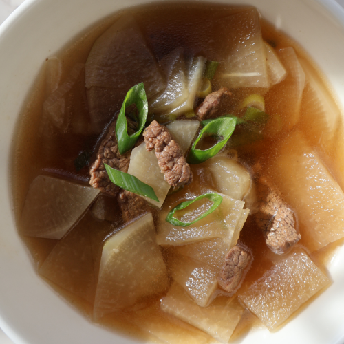 Korean radish soup with beef brisket and green onions in clear broth (mu guk)