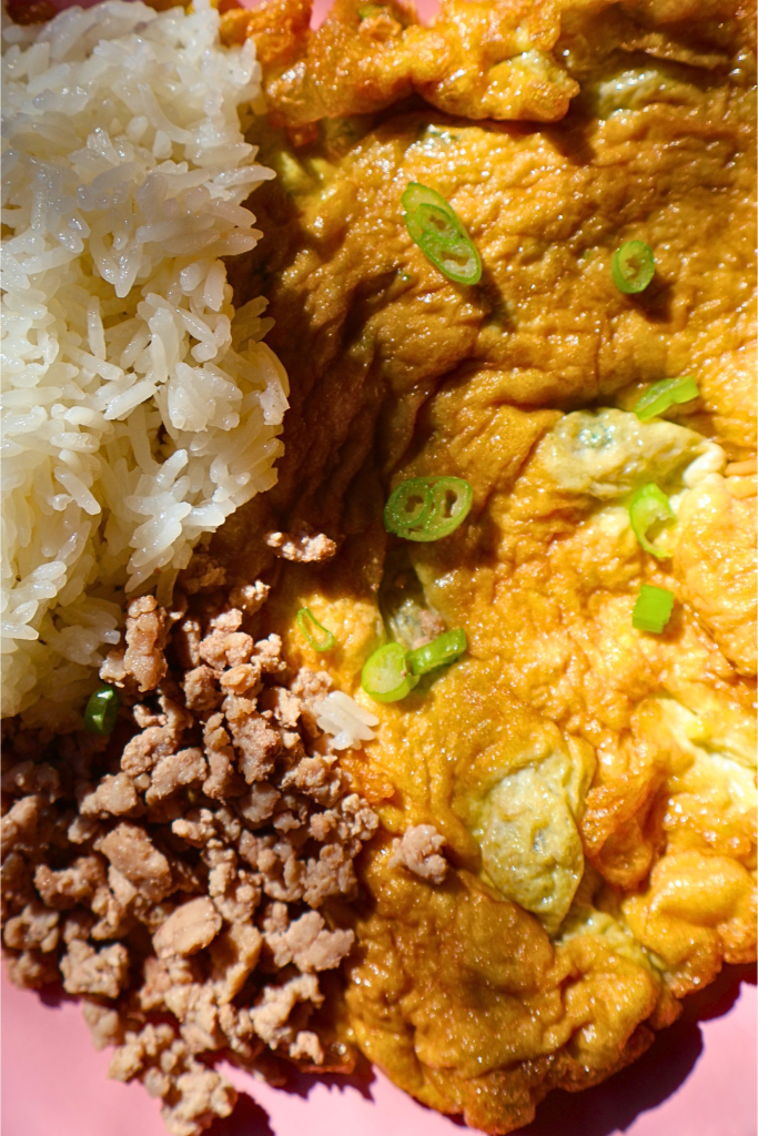 Thai omelet with jasmine rice and minced pork topped with green onions