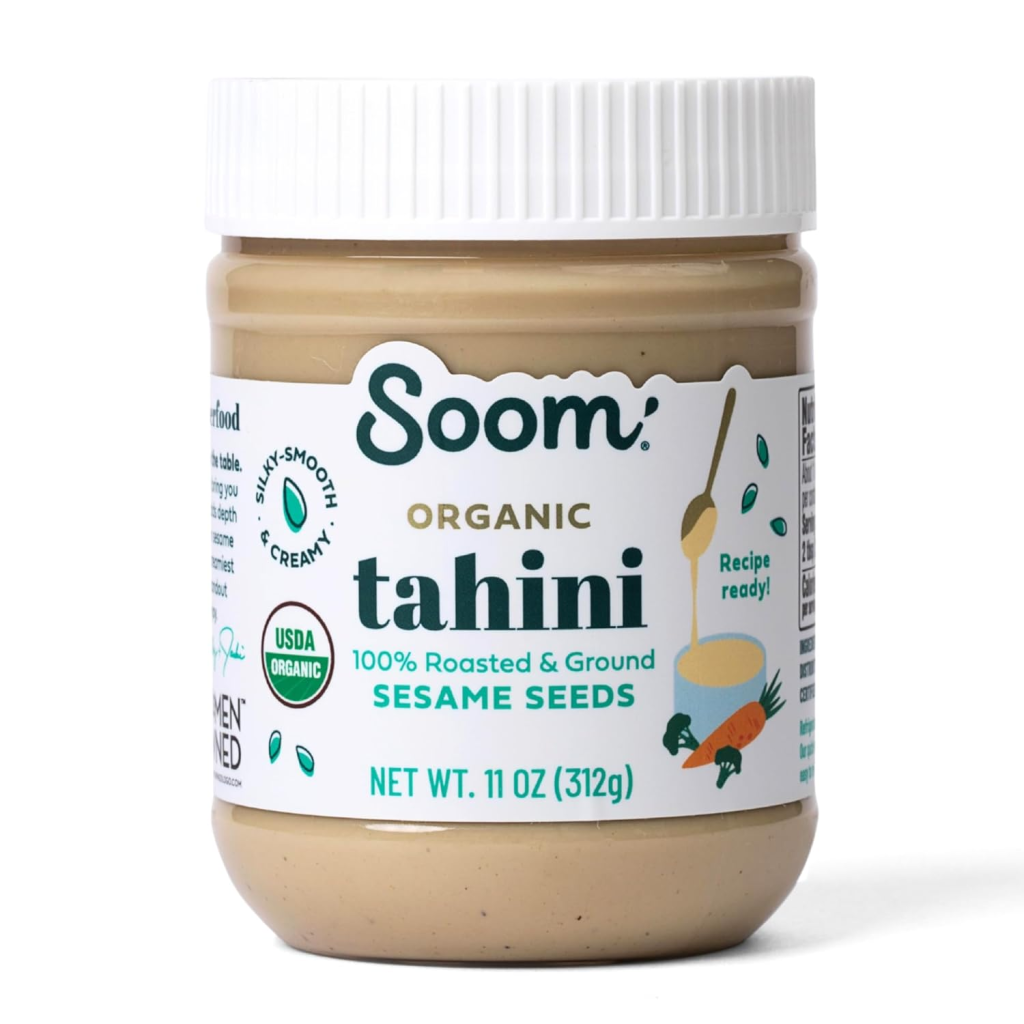 Jar of organic tahini, a smooth sesame seed paste used in hummus, dressings, sauces, baked goods, and Middle Eastern recipes.