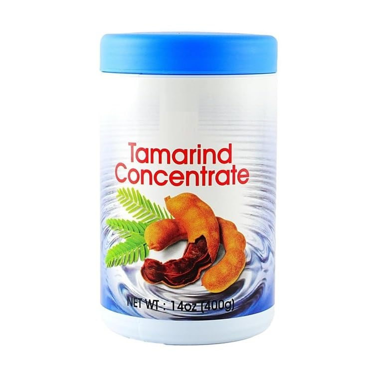 Jar of tamarind concentrate, a tangy fruit paste used to add sweet and sour flavor to curries, sauces, soups, marinades, and chutneys.