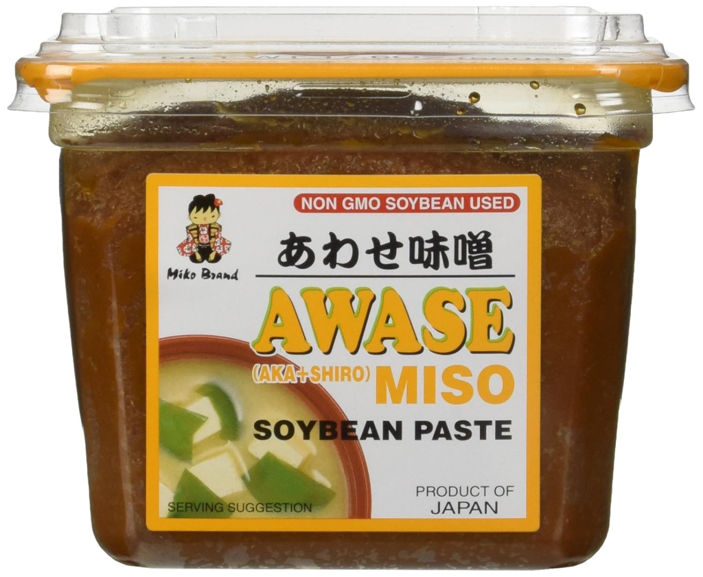 Container of awase miso, a Japanese blended miso paste made from red and white miso, used in soups, marinades, sauces, and glazes.
