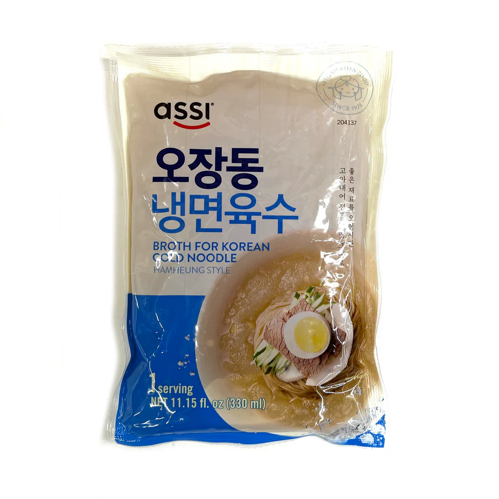 Package of uncooked naengmyeon noodles, traditional Korean buckwheat noodles used to make cold noodle dishes such as mul naengmyeon and bibim naengmyeon.