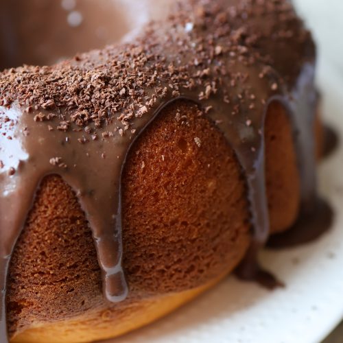 Brazilian carrot cake with brigadeiro chocolate topping dripping over a golden bundt cake