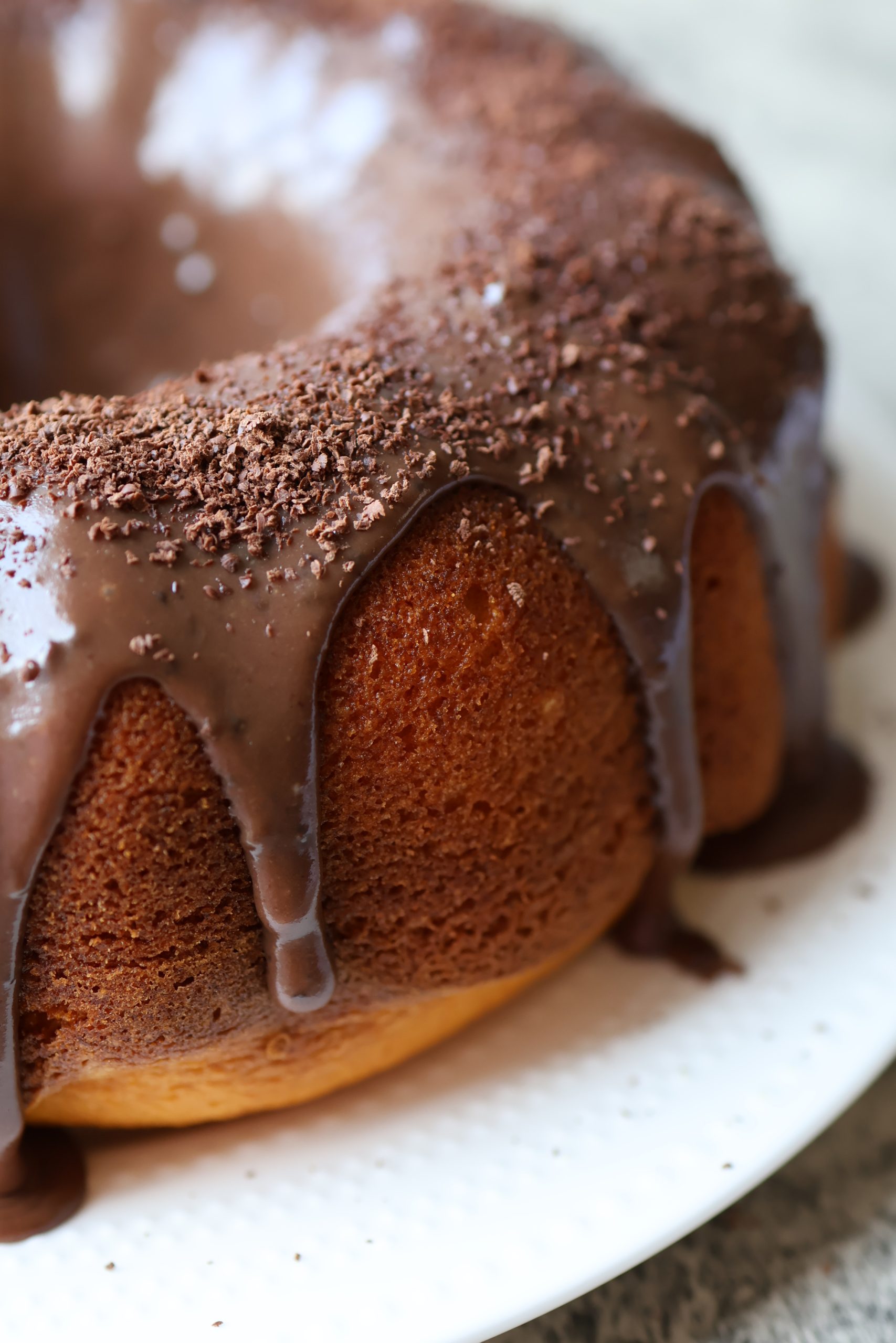 Brazilian carrot cake with brigadeiro chocolate topping dripping over a golden bundt cake