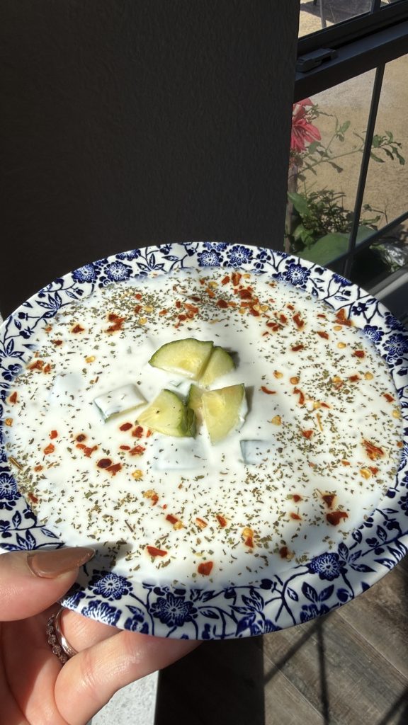 urkish cacık made with yogurt, cucumber, and herbs, garnished with dried mint and red pepper flakes.