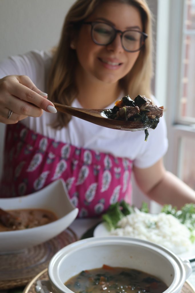 Emilia Kim serving romazava, Madagascar’s national dish, alongside steamed rice during her Hosting the World Madagascar dinner.