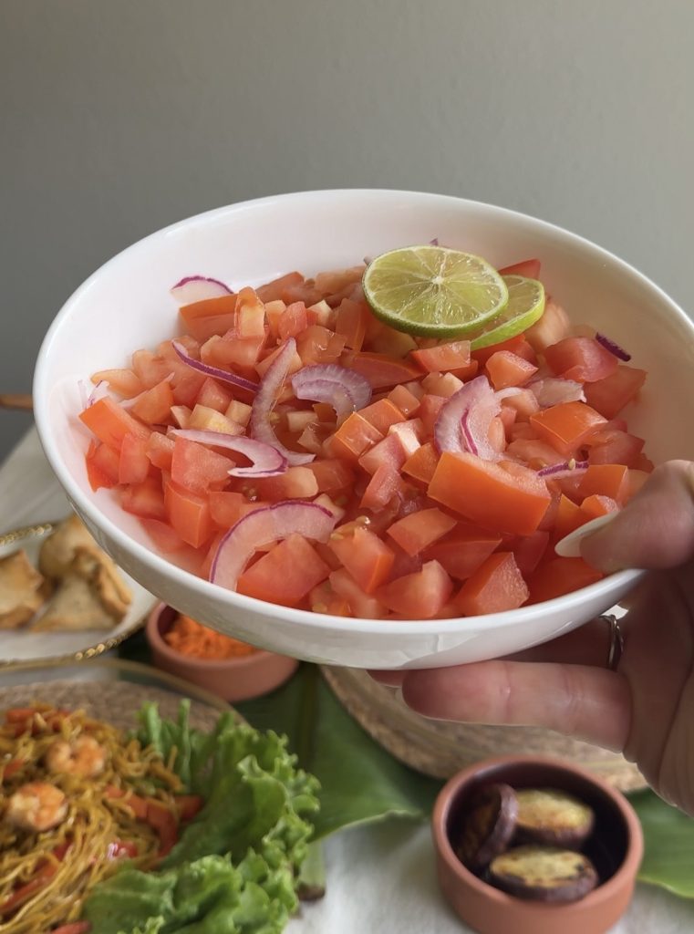Lasary Voatabia, a traditional Malagasy tomato salad made with fresh tomatoes, onions, and lime, served as a colorful side dish.