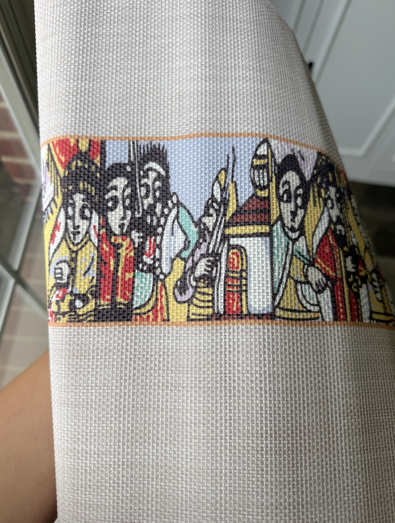 Traditional Ethiopian textile featuring colorful Ethiopian folk art figures and cultural motifs woven into a decorative table runner.