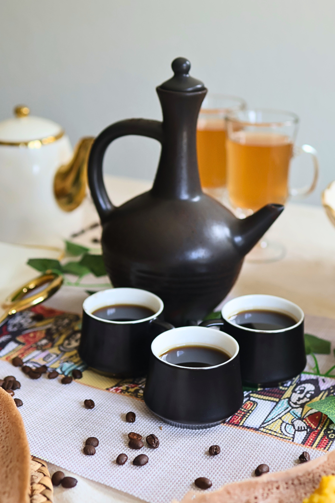 Traditional Ethiopian coffee ceremony with a jebena coffee pot and cups of freshly brewed Ethiopian coffee.