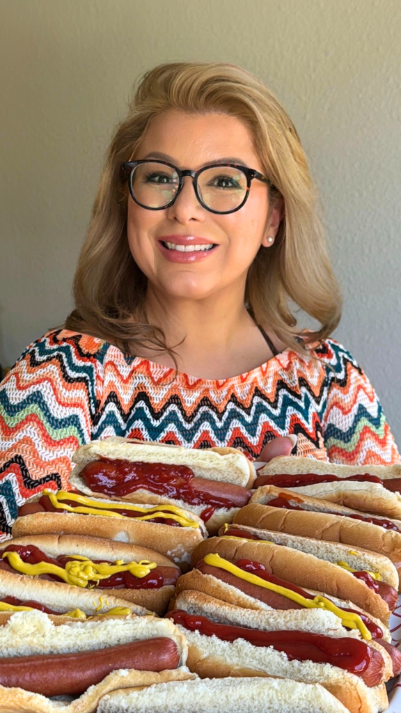 Woman holding several Chicago-style hot dogs during a Hosting the World USA food experience featuring classic American cuisine.