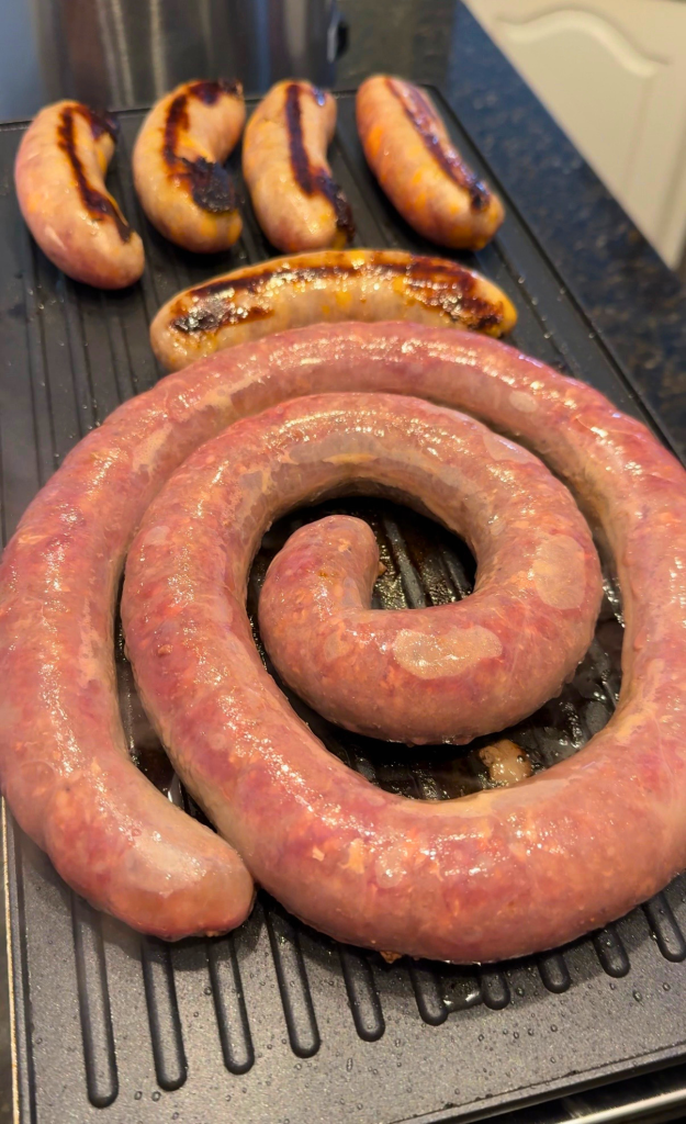 South African braai with boerewors sausage and grilled meat cooking over a hot grill