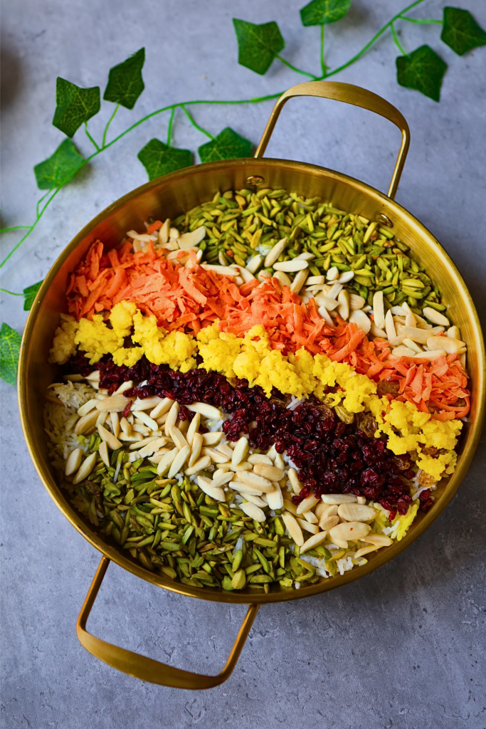 Morasa polo, traditional Persian jeweled rice topped with saffron, barberries, pistachios, almonds, carrots, and orange peel.