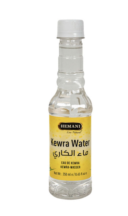 Bottle of kewra water with a white background, a fragrant floral essence commonly used in South Asian desserts and biryani.