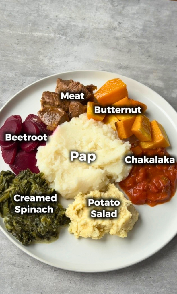 South African Seven Colours meal with pap, meat, butternut, chakalaka, potato salad, creamed spinach, and beetroot